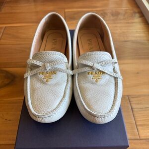 Prada CALZATURA DONNA Cream Pebbled Leather Slip-On Loafers with Gold Logo